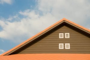 an orange roof with clouds in the background