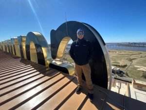 Dolan team member Chris Stephens standing on a roof