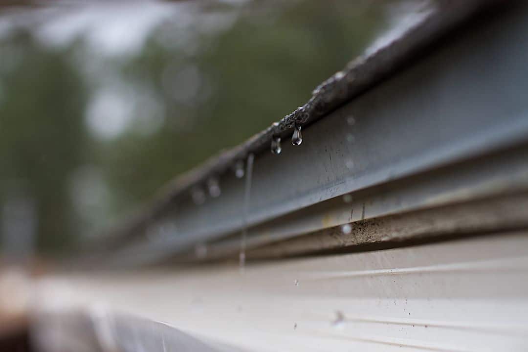 closeup of a roof dripping with rain
