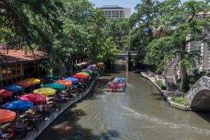 a boat traveling along the San Antonio Riverwalk