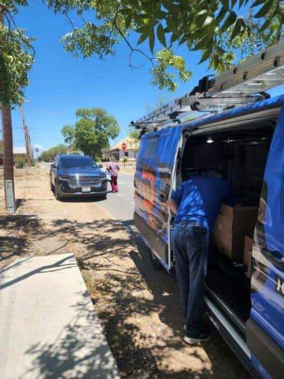 one of Dolan's roofing contractors preparing to deliver barbecue in Sabinal, TX