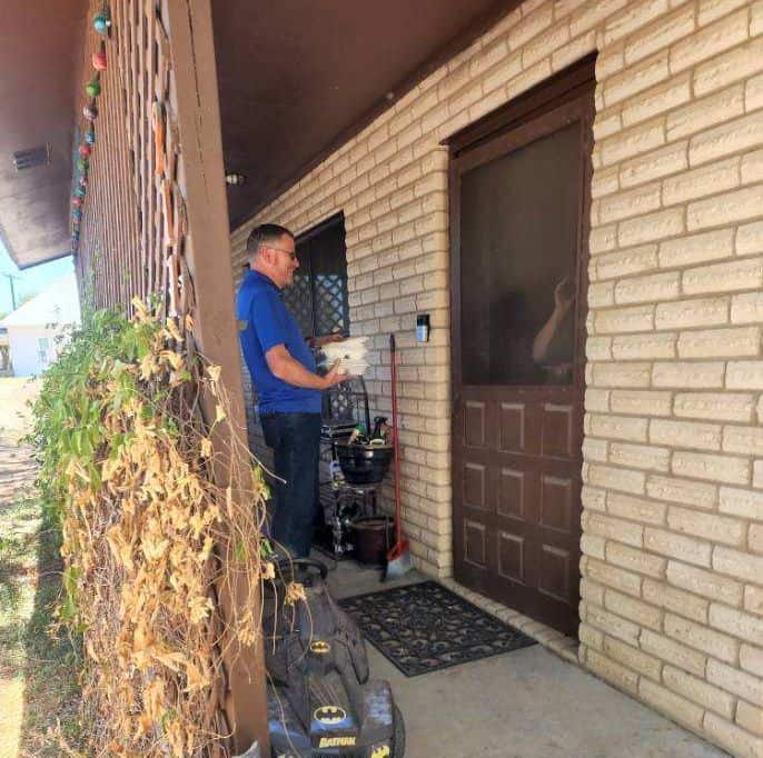 one of Dolan's roofing contractors deliver barbecue in Sabinal, TX