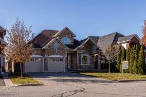 a home with added value from a new roof with a for sale sign