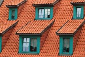 a multi-tiered tile roof with an aging underlayment