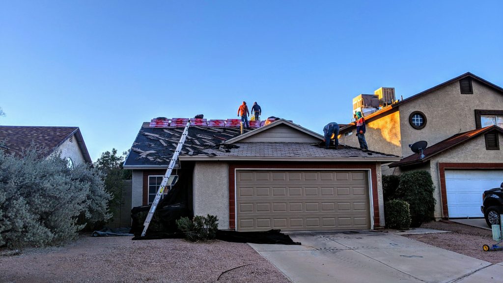 Crew replacing a roof