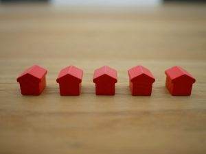 five red wooden toy houses